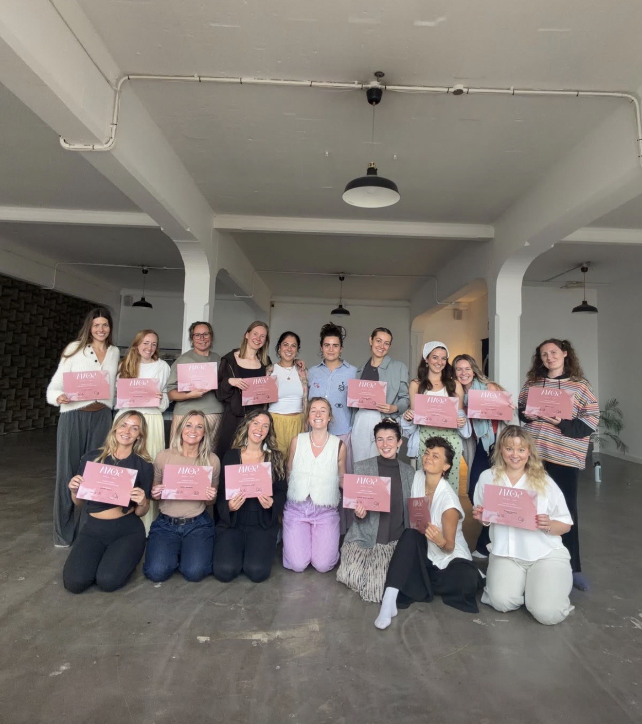 Leanne with her SOMA School training group and their certificates